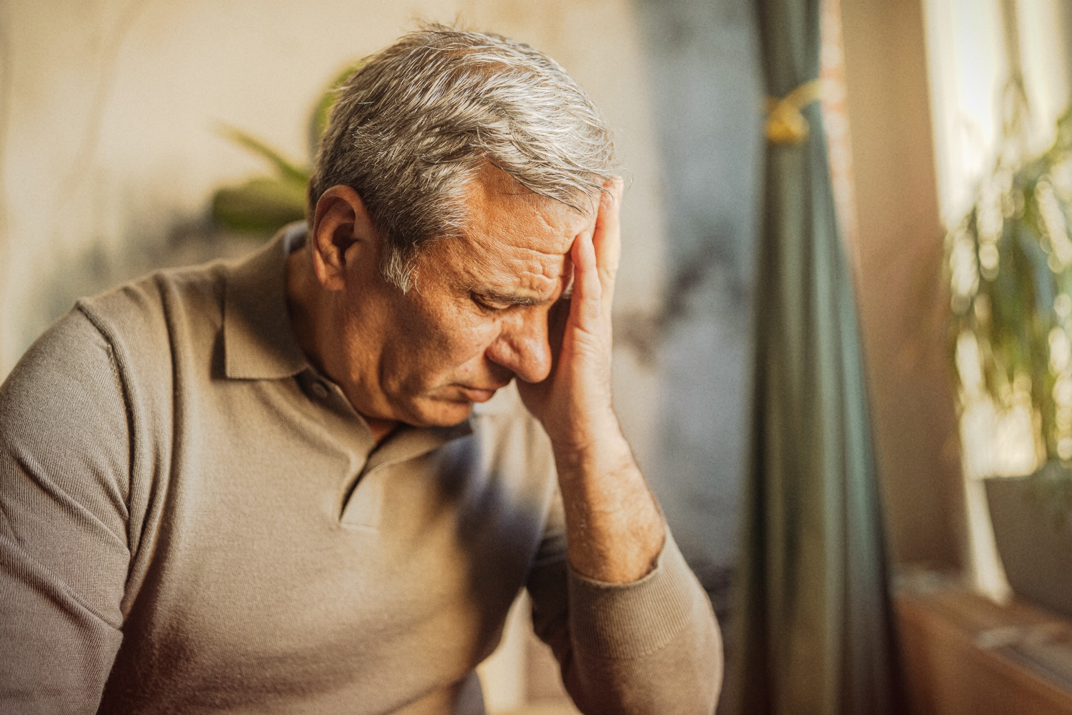 Man suffering from headache, a common symptom of chikungunya.