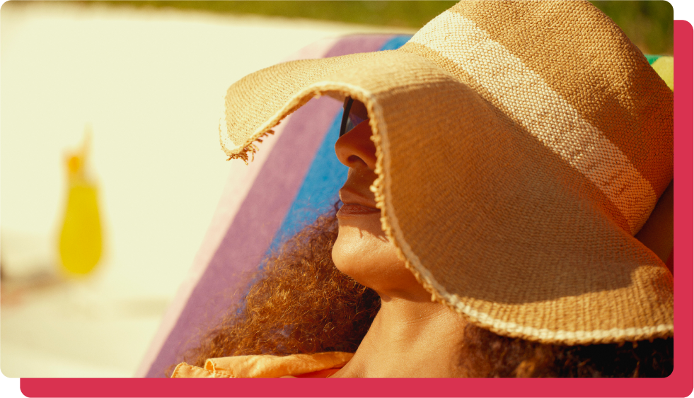 Female wearing hat as protection against mosquitos while sunbathing poolside.